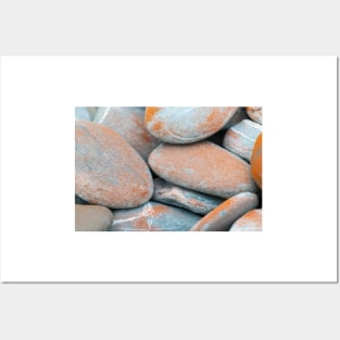 Beach stones in grey with orange coloured lichen growth Posters and Art